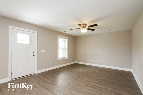 a bedroom with a ceiling fan and a white door