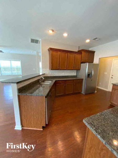 a kitchen with a sink and a refrigerator
