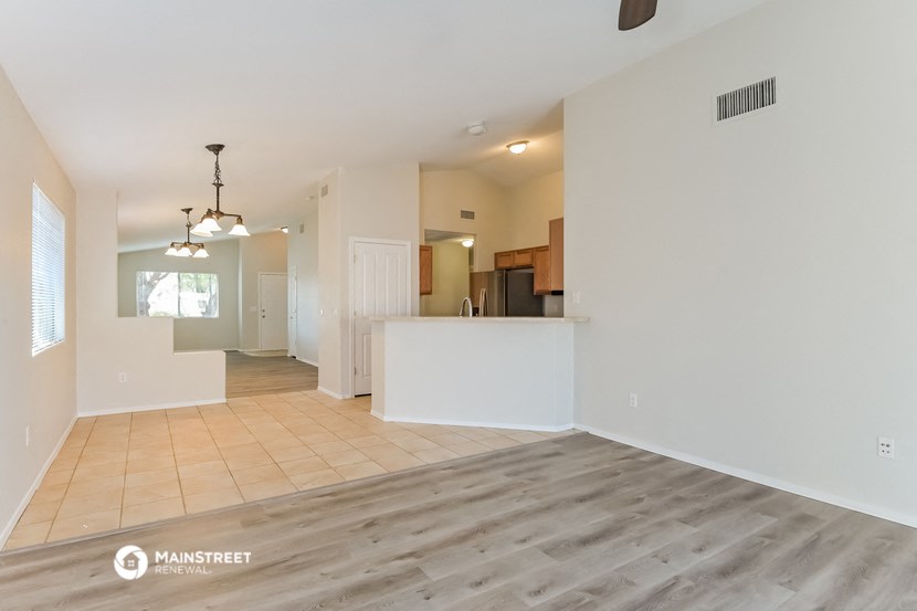 the living room and kitchen are open to the dining and kitchen area