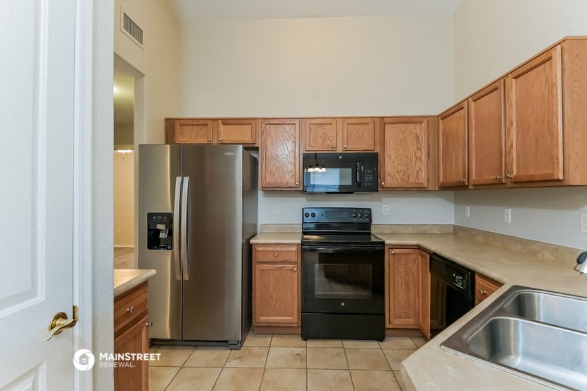 a kitchen with stainless steel appliances and wooden cabinets