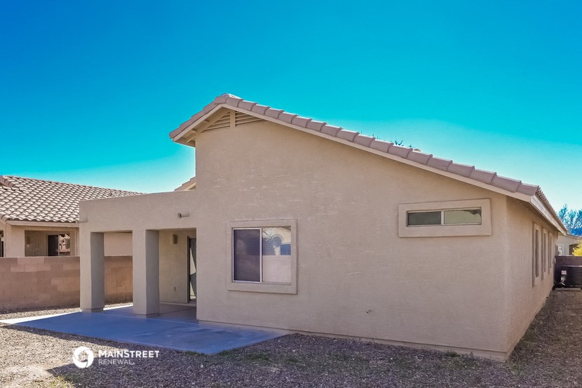 a beige house with a blue sky in the background