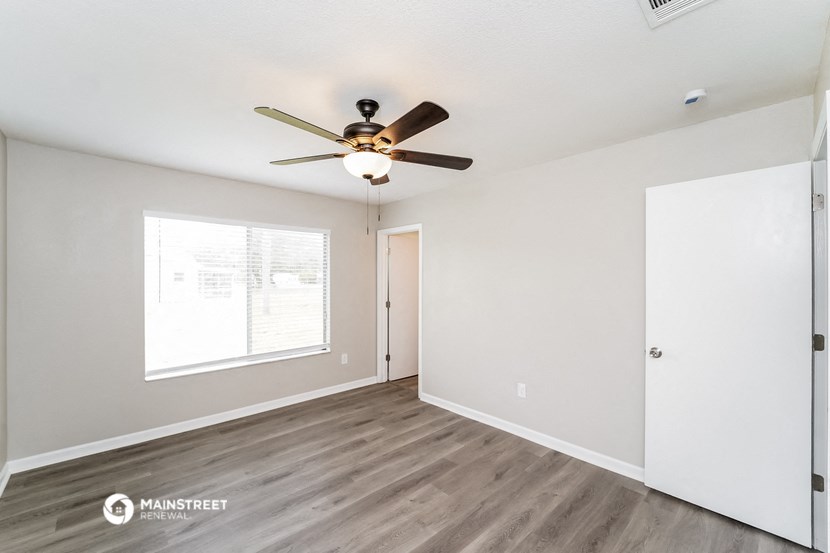 the living room of our two bedroom apartment atrium with ceiling fan and window