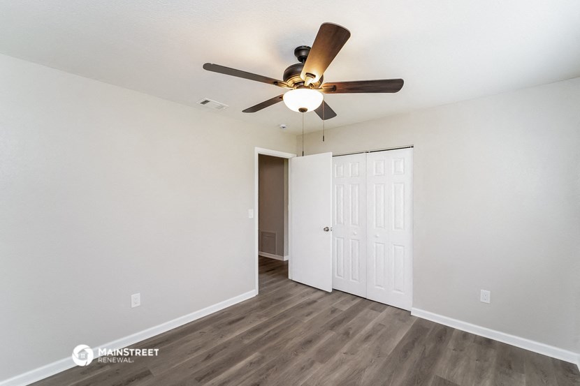 the living room of our studio apartment atrium with ceiling fan and closet