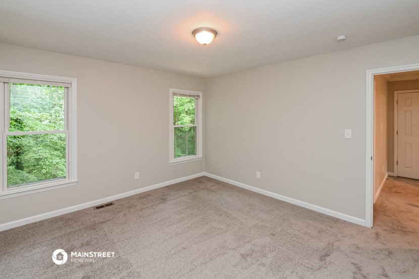 the master bedroom is spacious and has a door to the backyard