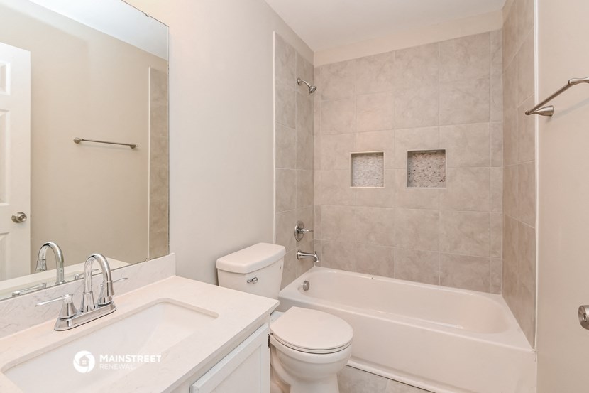a bathroom with a sink toilet and a bath tub