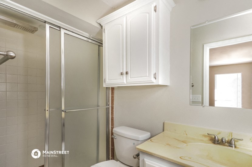 a small bathroom with a shower and a sink and a toilet