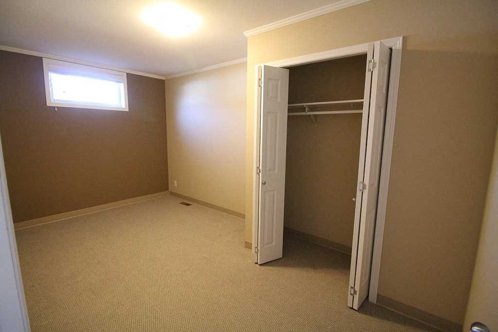 an empty room with a closet and a open door