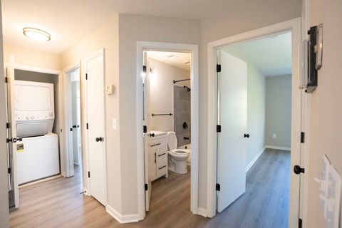a renovated living room with a bathroom and a laundry room