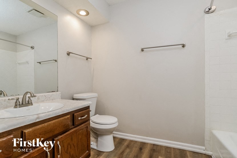 a bathroom with a toilet and a sink and a mirror