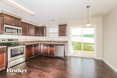 a kitchen with wooden cabinets and stainless steel appliances