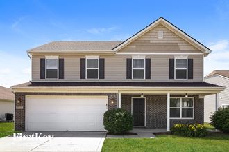 a house with a white garage door in front of it