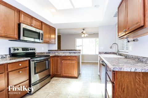 A kitchen with wooden cabinets and a stainless steel stove.