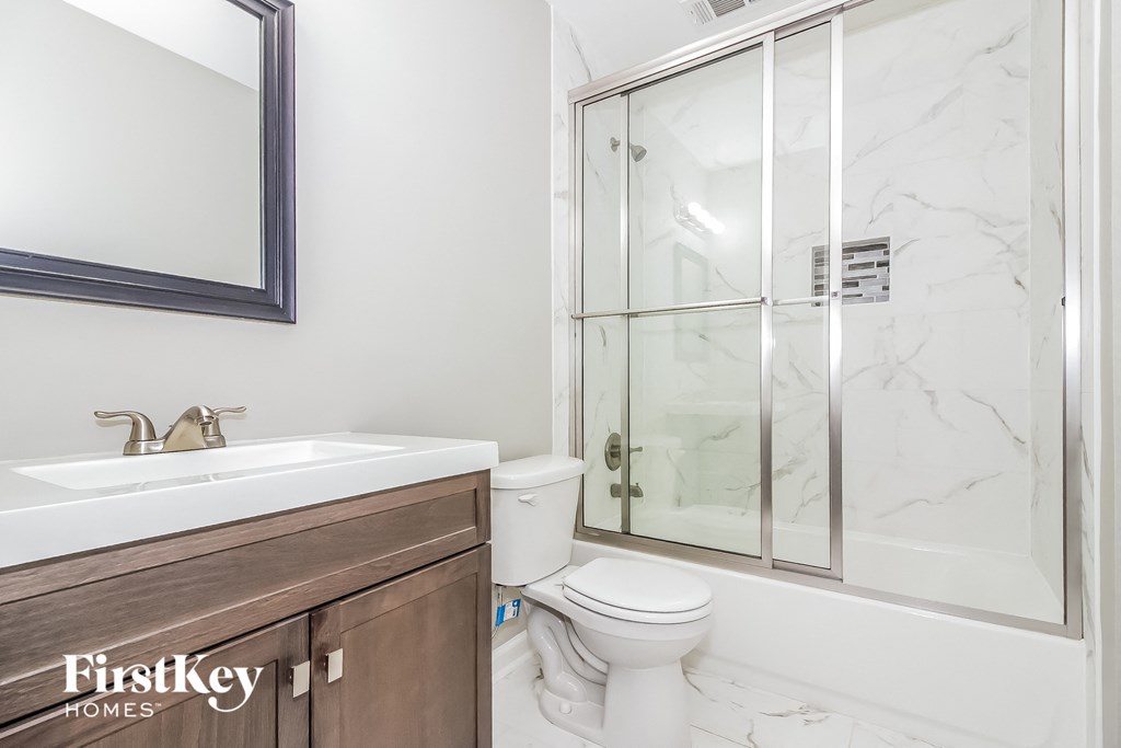 a bathroom with a sink toilet and a shower
