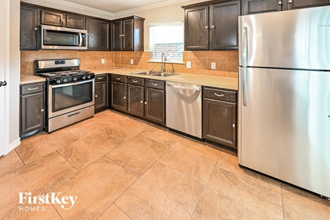 a kitchen with stainless steel appliances and wooden cabinets