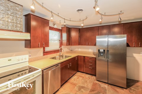 A kitchen with wooden cabinets and stainless steel appliances.