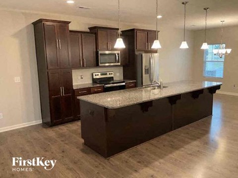 a kitchen with an island and dark wood cabinets