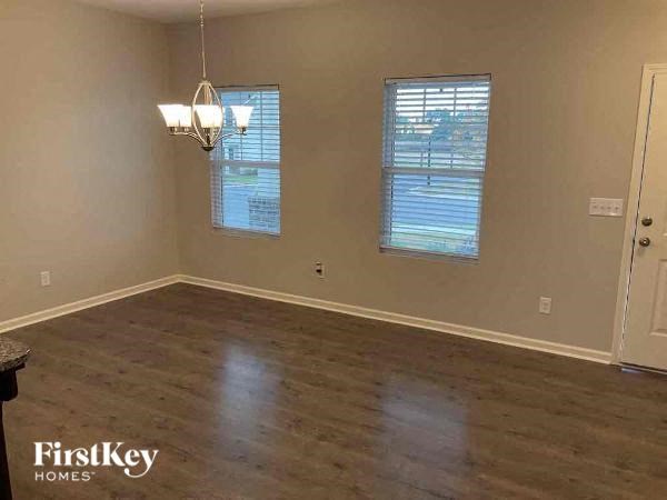 an empty living room with a hard wood floor