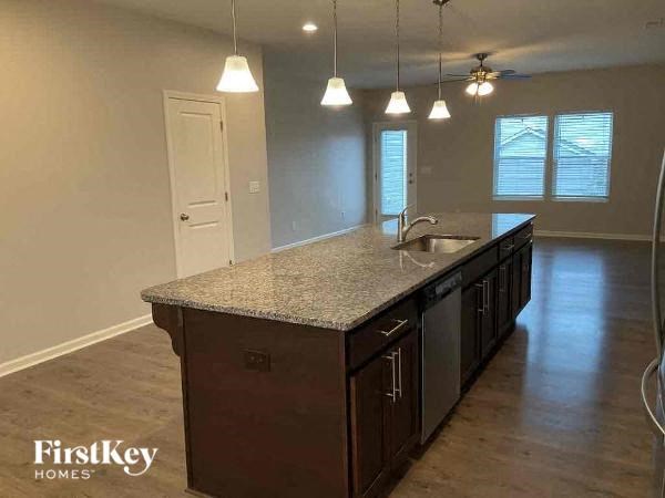 an empty kitchen with a counter top and a sink