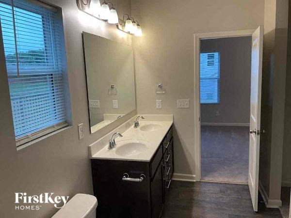 a bathroom with a white sink and a mirror