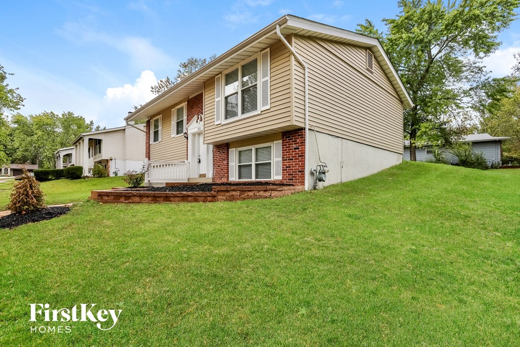 a house on a hill with a lawn and a yard