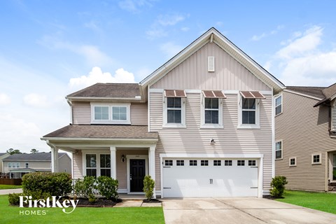 a beige house with a white garage door