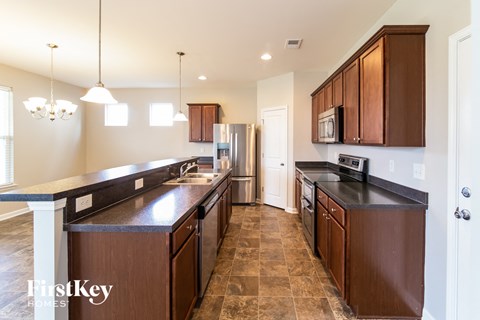 a kitchen with wooden cabinets and stainless steel appliances