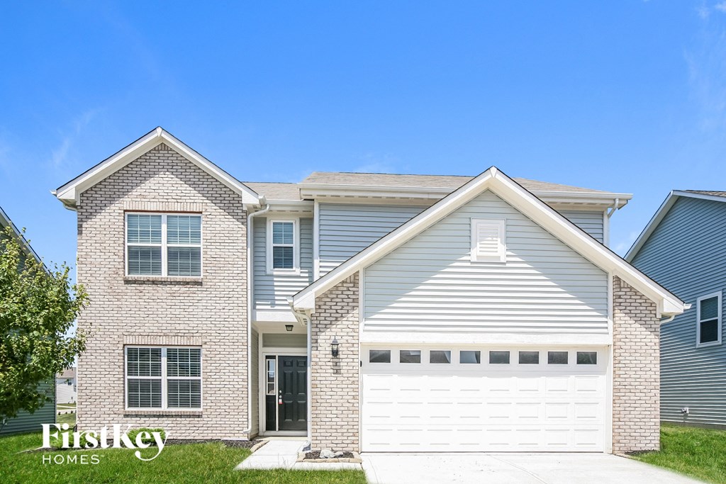 a white garage door in front of a house