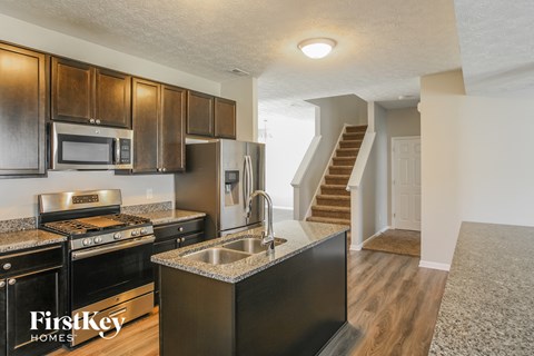 a kitchen with stainless steel appliances and granite counter tops