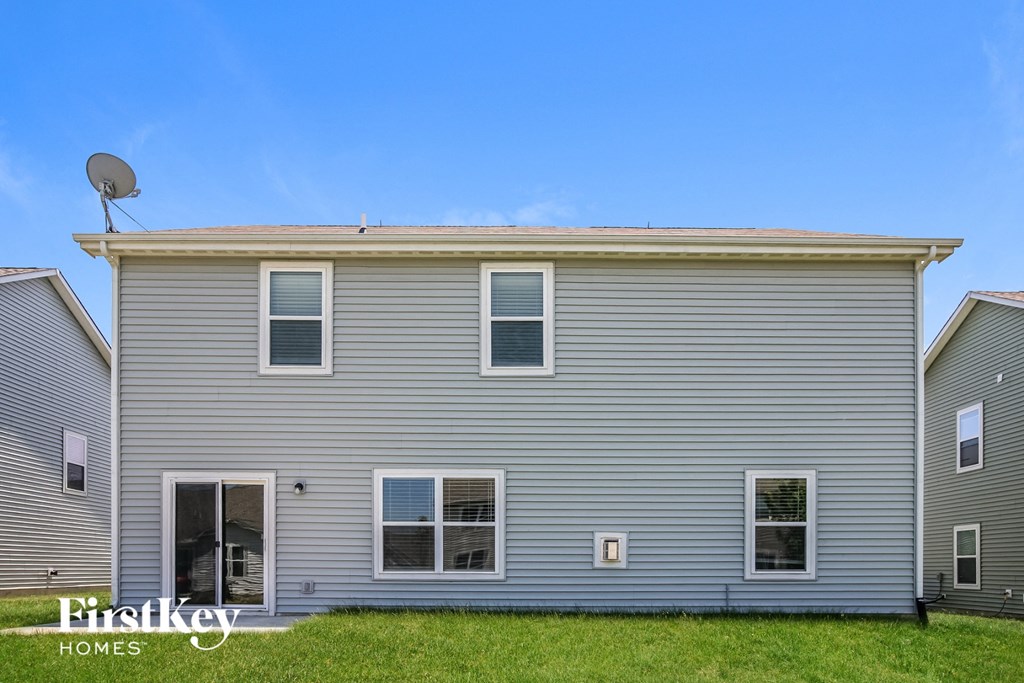 a gray house with a blue sky in the background