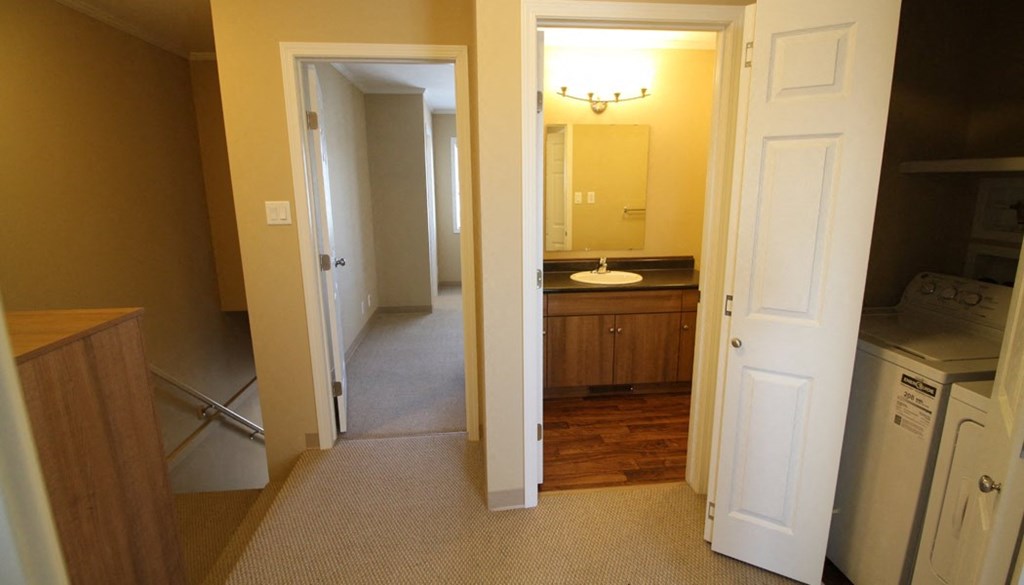 a kitchen and a bathroom with a sink and a mirror