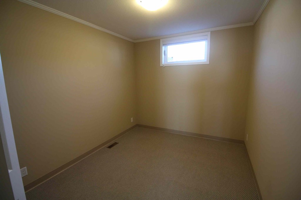 a room with a window and a carpet