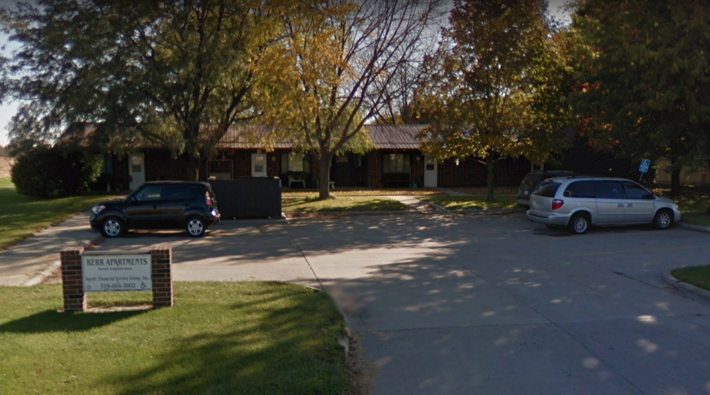 a parking lot in front of a building with cars parked