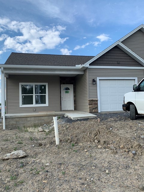 a house with a white truck parked in front of it