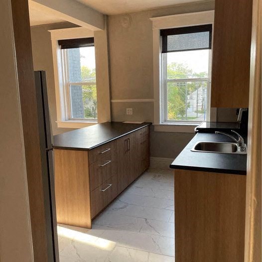 a small kitchen with a sink and a refrigerator