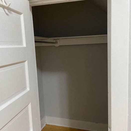 an empty closet with the door open