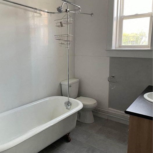 a bathroom with a tub and a toilet and a sink