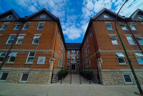 an old brick building with a blue sky in the background