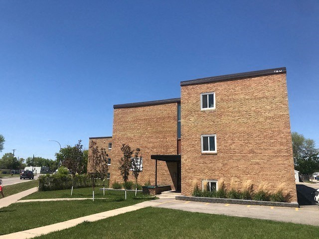 a brick building on the side of a street