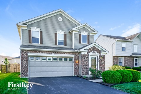 a house with a garage door in front of it