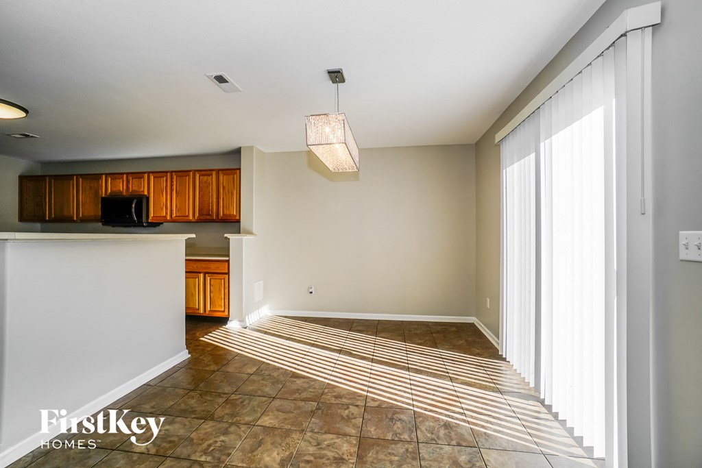 an empty kitchen and living room with a large window