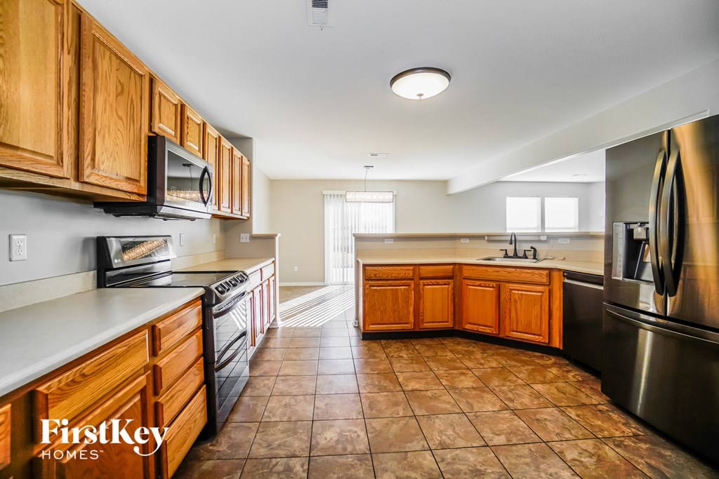 a kitchen with wooden cabinets and stainless steel appliances