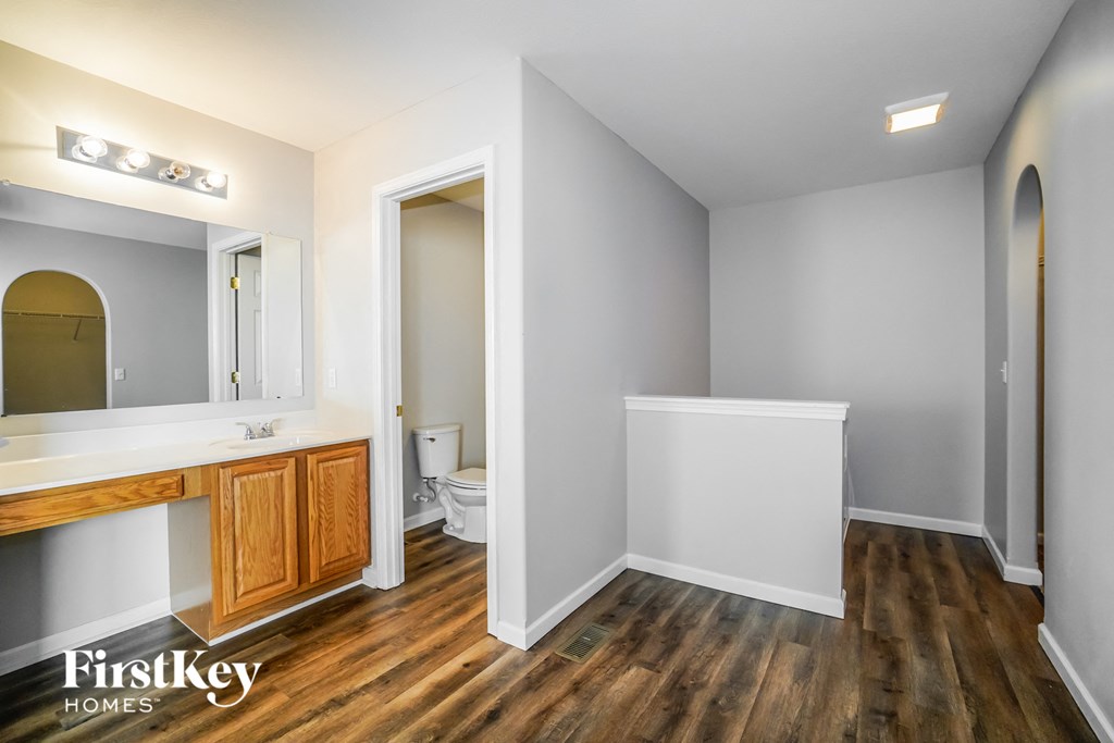 a bathroom with a toilet and a sink and a mirror
