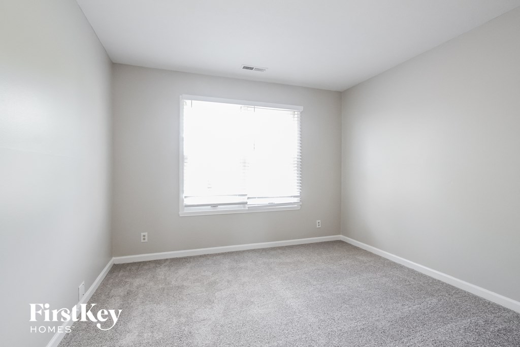 a room with carpet and a window in it