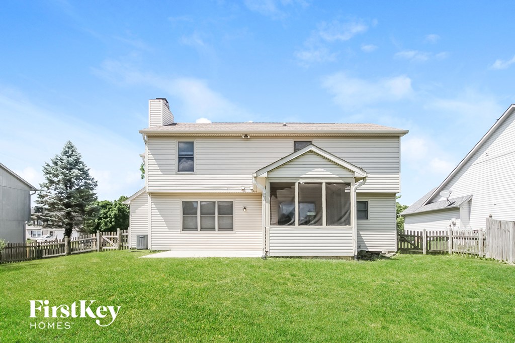 a white house with a yard in front of it