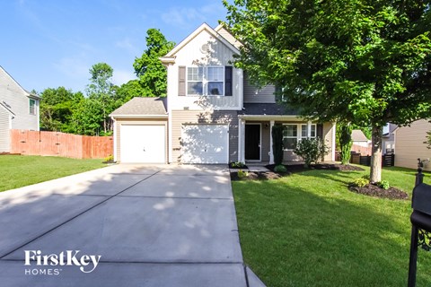 A house with a white garage door is for sale.