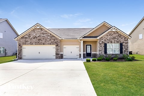 A house with a garage and a driveway in front.