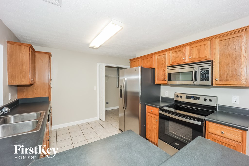 a kitchen with stainless steel appliances and wooden cabinets