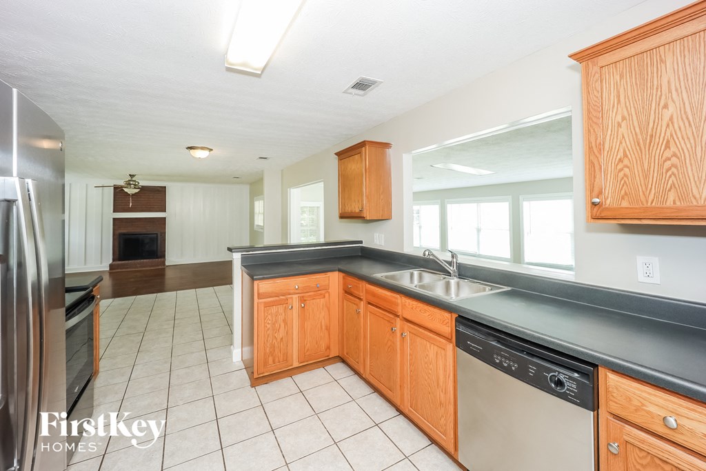 a kitchen with wooden cabinets and a sink and a dishwasher