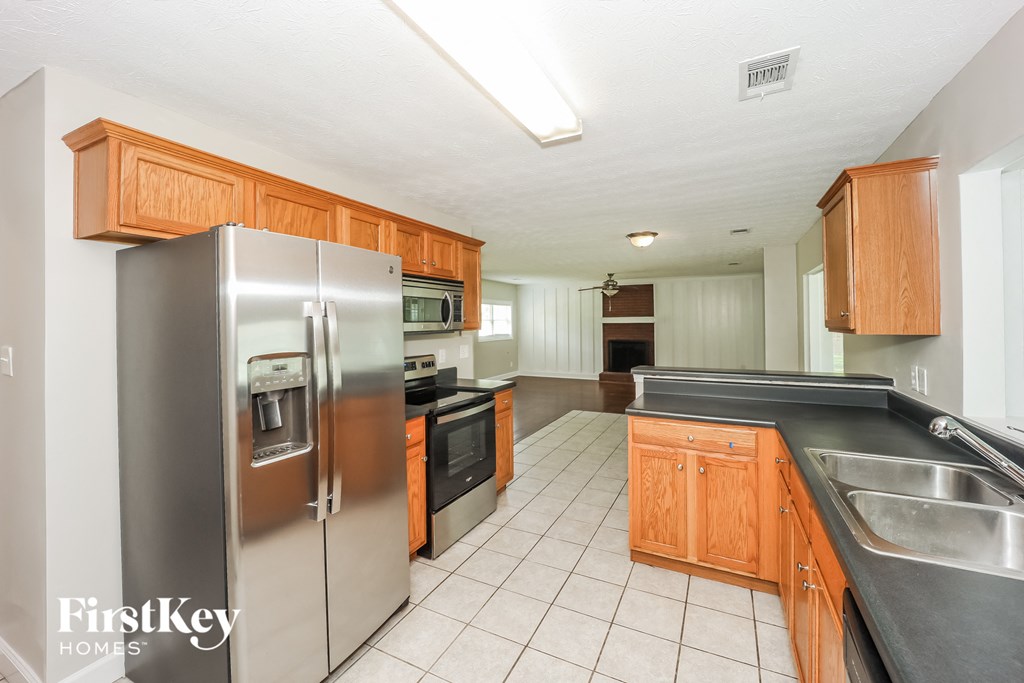 a kitchen with stainless steel appliances and wooden cabinets