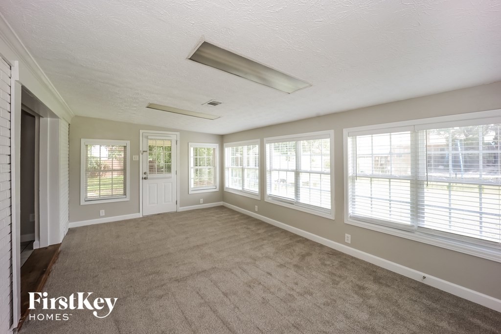 the living room is spacious and has a lot of windows